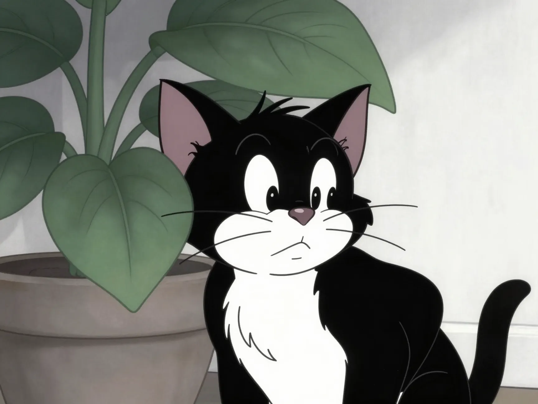 Sylvester cat peeking from behind potted plant